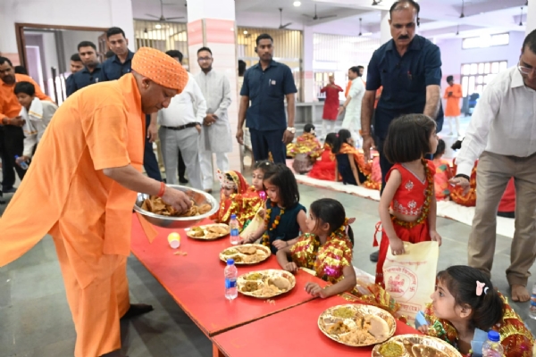 During the Kanya Pujan ritual, the Chief Minister personally served food with his own hands and sought blessings from the young girls by offering them *Dakshina* and gifts.