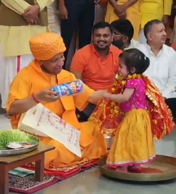 During the Kanya Pujan ritual, the Chief Minister personally served food with his own hands and sought blessings from the young girls by offering them *Dakshina* and gifts.