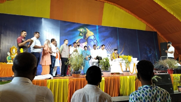 श्रीमद् भागवत कथा सुनने पहुंचे ब्यास पीठ पर विराजमान गुरुजी के सामने खड़े जिलाधिकारी डॉ दिनेश चंद्र सिंह सीडीओ ध्रुव खड़िया और अन्य भक्त