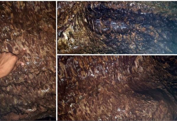 गुफा के अंदर चट्टानों से टपकती पानी की बूंदें,