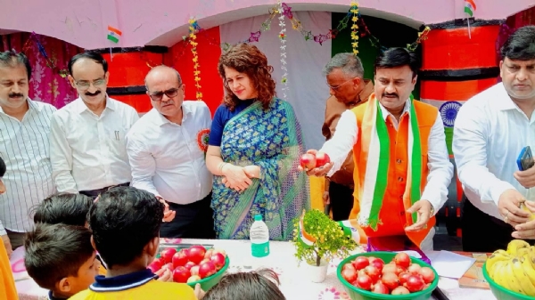 बच्चों को फल वितरित करते समाजसेवी